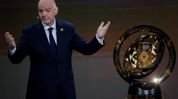 O presidente da FIFA, Gianni Infantino, com o troféu antes do sorteio [Brian Snyder/Reuters]